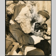 Michael Bitow sits with Santa Claus (ddr-densho-395-42)
