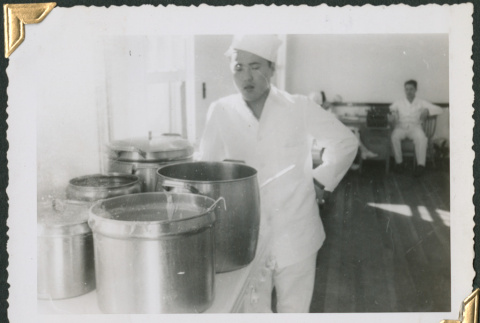 Man standing by large pots in kitchen (ddr-densho-434-283)
