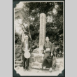 Man and woman pose in front of Japanese monument (ddr-densho-359-1029)