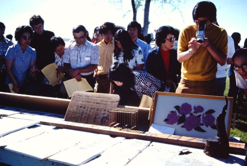 Pilgrims looking at a photograph display at the former site of Tule Lake (ddr-densho-294-32)