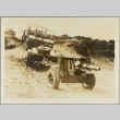 Soldiers riding in a truck towing a gun and other equipment (ddr-njpa-13-1512)