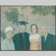 Man in graduation robe with Agnes and Chester Sakura and another woman (ddr-densho-523-428)