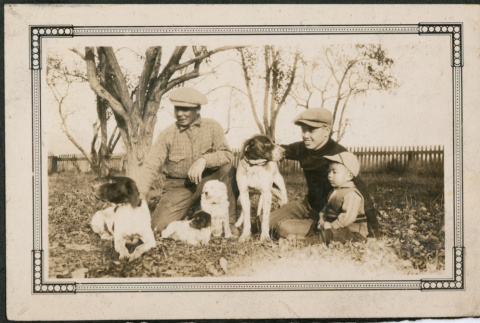 Two men and a boy with four dogs (ddr-densho-293-63)