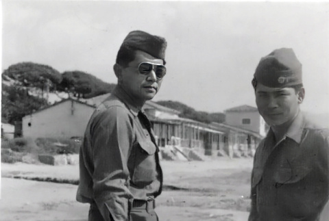 Two men in fatigues standing on beach (ddr-densho-474-240)