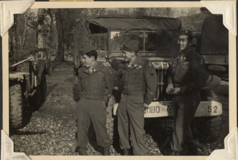 Three men standing by army truck (ddr-densho-466-742)