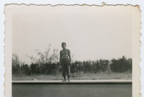Man standing on ledge of pool (ddr-densho-368-66)
