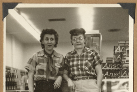 Two women leaning against a counter (ddr-densho-542-122)