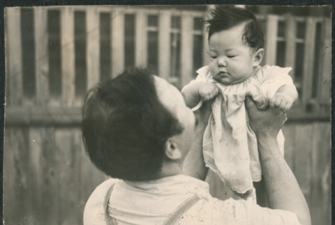 Man holding baby (ddr-densho-523-65)