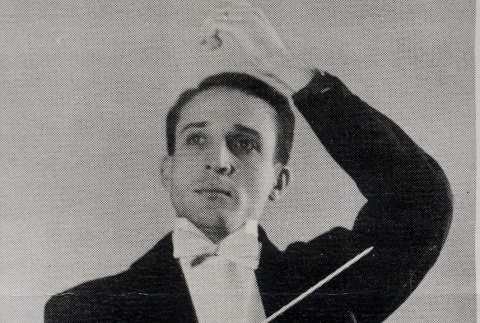 Conductor wearing tuxedo and posing with wand (ddr-njpa-2-424)