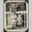 Two Nisei brothers in front of a fence (ddr-densho-259-180)