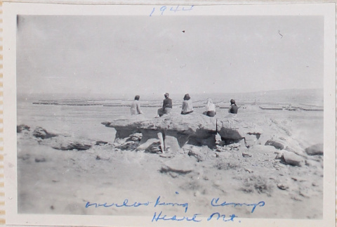 Five women sitting on rocks on hillside (ddr-densho-464-65)