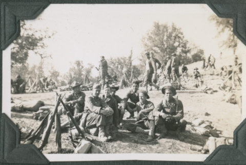 Group of men sitting on hillside (ddr-ajah-2-190)