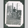 Man by log pile (ddr-densho-471-70)