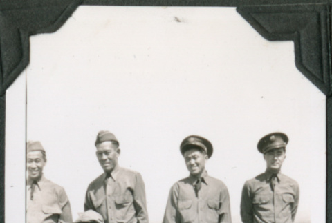 Four men in uniform standing on hill (ddr-ajah-2-143)