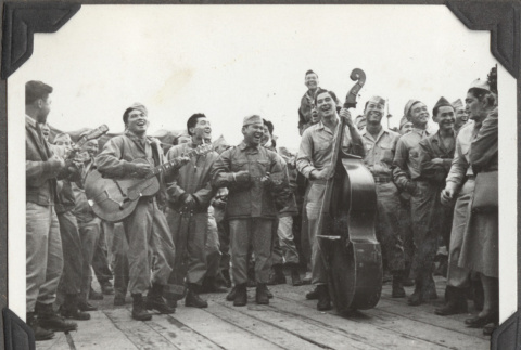 Group of soldiers playing instruments on ship's deck (ddr-densho-466-152)