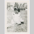 Young girl sitting in grass (ddr-densho-332-6)