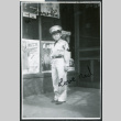 Photograph of Ned Morioka posing in front of a store front (ddr-csujad-47-140)