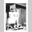 Nisei man and woman in front of barracks (ddr-densho-157-33)