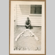 Man posing with A made of rocks (ddr-densho-368-495)