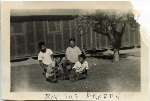 Four boys sitting in front of barracks (ddr-manz-6-109)