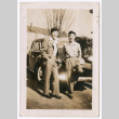 Two men lean on a car (ddr-densho-463-105)