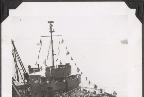 Tug boat with flags seen from ship (ddr-densho-466-166)