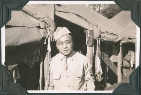 Man standing outside tent (ddr-ajah-2-586)