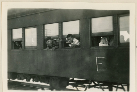Young men looking out from a train car (ddr-densho-37-916)