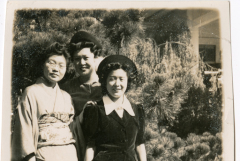 Tomoye (Nozawa) Takahashi and two unidentified women standing in garden (ddr-densho-426-2146)