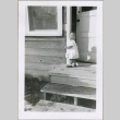 A baby in the doorway of a housing project apartment (ddr-densho-300-58)