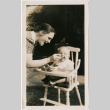 Woman feeding baby sitting in high chair (ddr-densho-426-2107)