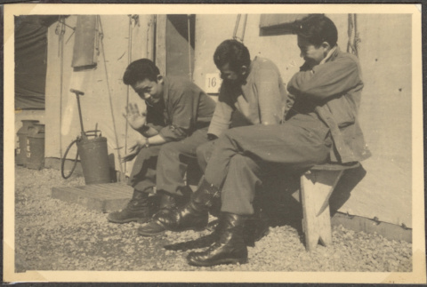 Three men sitting outside building (ddr-densho-466-30)