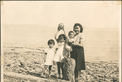 Woman and three children at beach (ddr-densho-321-264)