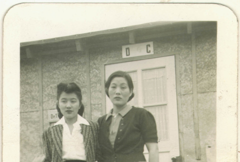 Mother and daughter in front of barracks (ddr-densho-118-11)