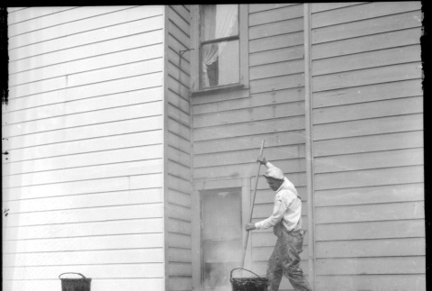 Man laying tarpaper (ddr-densho-426-2172)