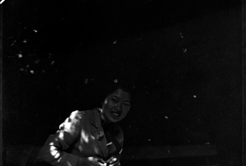 Woman sitting on bench feeding a squirrel (ddr-densho-426-1907)