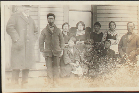 A family posing in front of a house (ddr-densho-278-113)