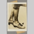 Photograph of a small lamp[?] attached to a woman's shoe (ddr-njpa-13-1345)