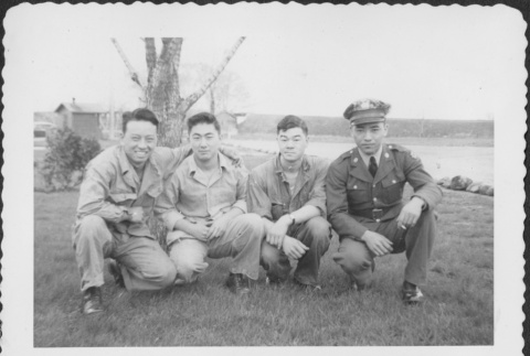 Four men posing for photo alongside river (ddr-densho-434-400)