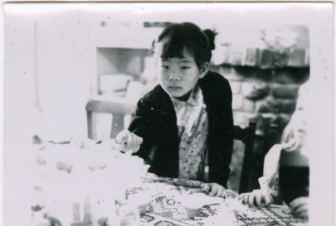 Masako Takahashi at a table with cake (ddr-densho-426-994)