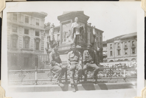 Three men sitting on rail by fountain (ddr-densho-466-635)