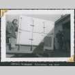 Man with large icebox on loading dock (ddr-densho-434-258)