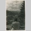 Man looking out over rooftops (ddr-densho-201-434)
