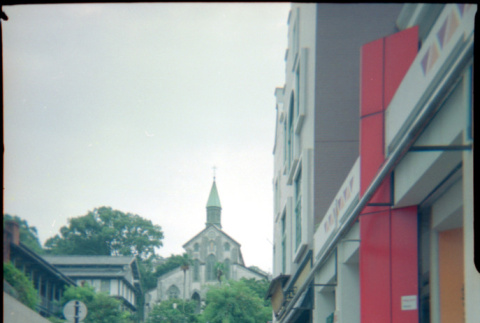 Henri Takahashi on street leading to Oura Church, Nagasaki (ddr-densho-426-496)