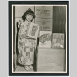 Girl posing with Tea Cakes (ddr-densho-499-23)
