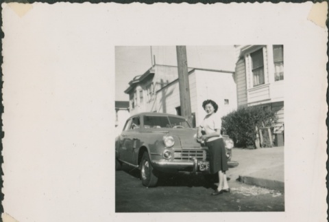 Woman leaning on a car (ddr-densho-321-1123)
