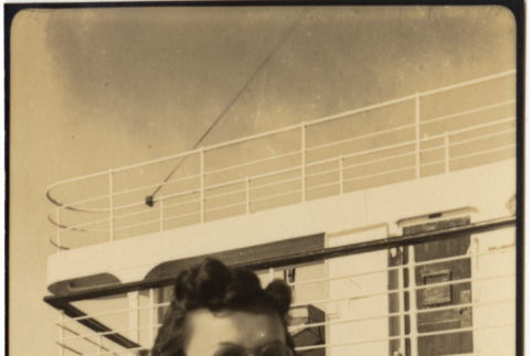 Woman sitting on deck of ship (ddr-densho-426-1800)