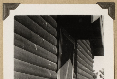 Lloyd Sato beside a cabin (ddr-densho-542-477)