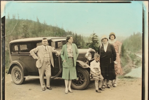 Caucasian family next to touring car (ddr-densho-259-395)