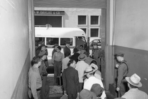 Indonesians boarding buses in San Francisco to be taken to a waiting train (ddr-csujad-27-9)
